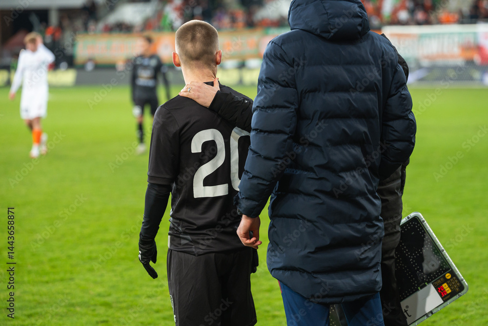 The back of a reserve player before entering the pitch.