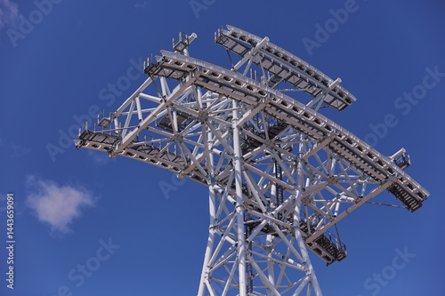 Wallpaper Mural Cableway support tower against blue sky. Construction of cross-border cableway between Russia and China. Support made of white pipes in Blagoveshchensk. Concept construction technologies. Torontodigital.ca