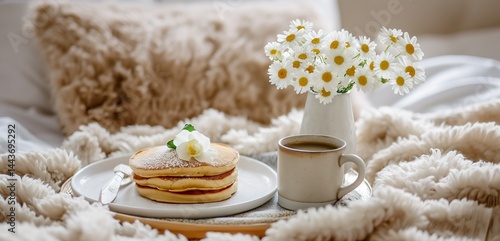 Obraz na płótnie Morning Comfort: Stack of pancakes, steaming mug, and blooms on a cozy bedspread with open space w salonie