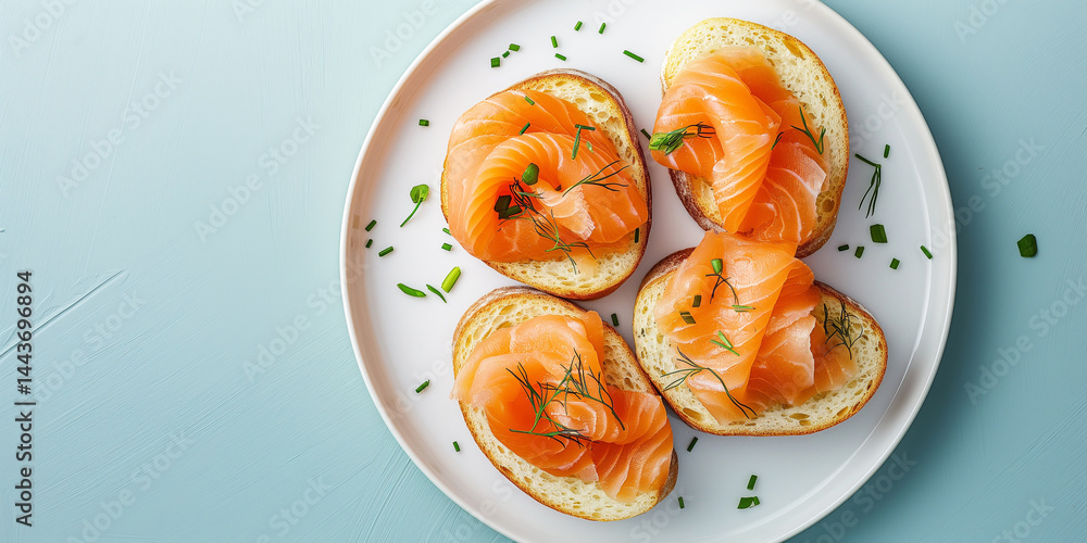 Salmon Bites: Smoked salmon crostini aligned right on pale blue, text area left