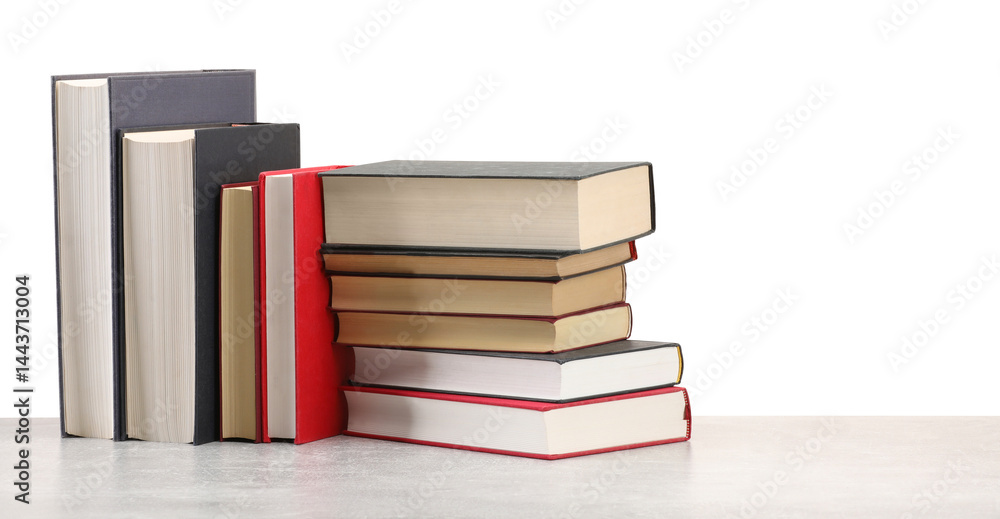 Old books on light grey table against white background Old books on light grey table against white background