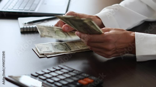 Close up view of woman's hands and Indian rupee (INR) banknotes. Concept of bank office work, saving money for retirement, cash settlement, financial success, literacy and income planning in India. 