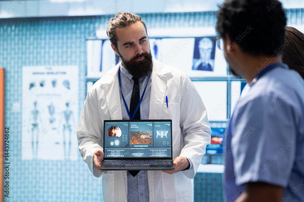 Professional medic analyzing mri brain scan with his staff in medical office, neuroscientist examining tomography with diverse team of doctors. Experts in neuroscience at treatment center.