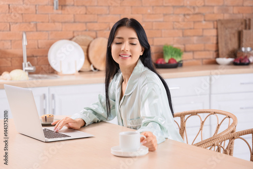Young woman with laptop and...