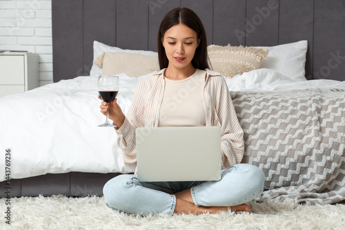 Young Asian woman with glas...