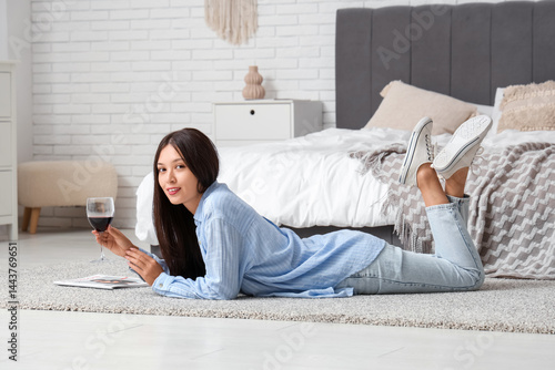 Young Asian woman lying on ...