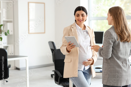 Pregnant businesswoman with...