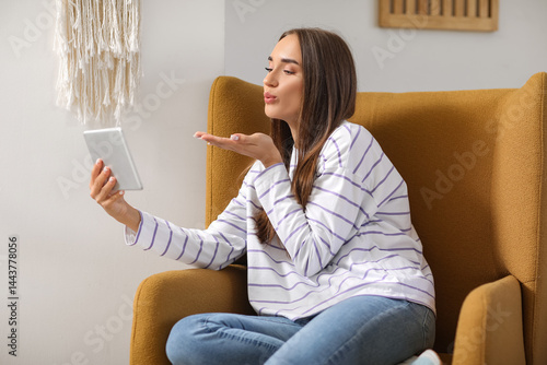 Young woman video chatting ...