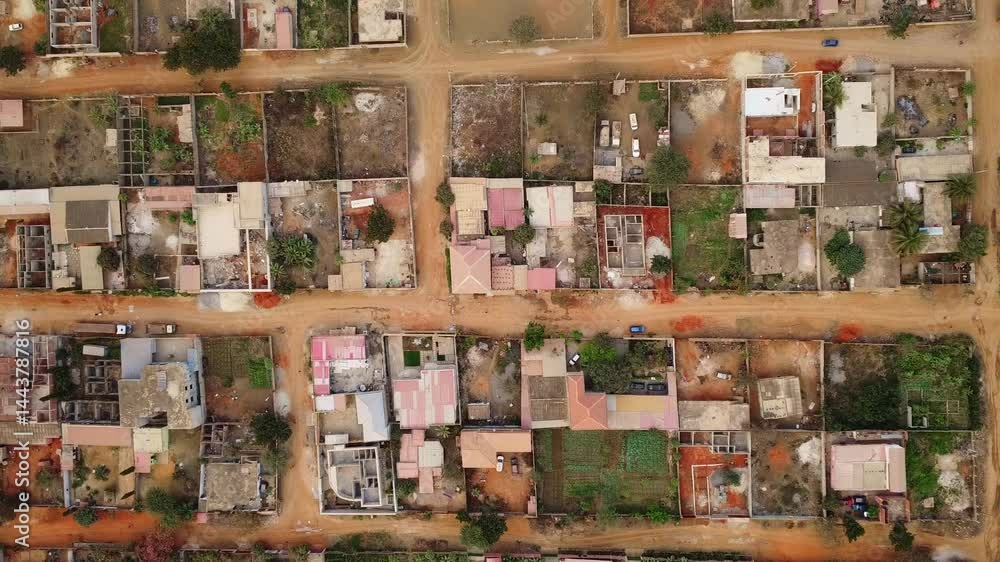 aerial shot of a residential area shows houses and dirt roads in a developing country landscape view Angola aerial shot of a residential area shows houses and dirt roads in a developing country landscape view Angola