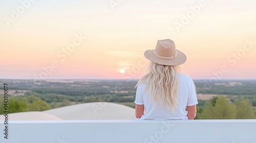 Woman enjoying sunset view from elevated platform