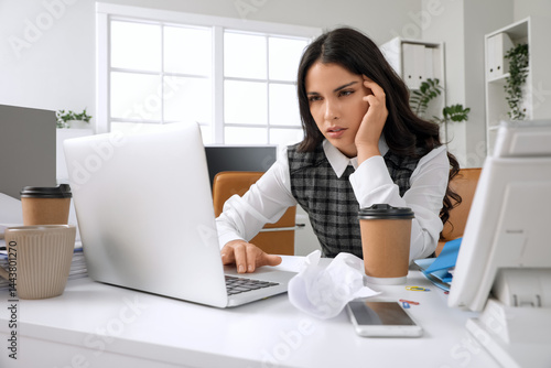 Tired young woman with lapt...