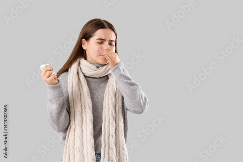 Ill young woman with tissue...