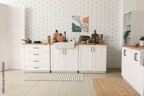 Obraz na płótnie Kitchen counter and folding screen near white brick wall in interior of kitchen w salonie