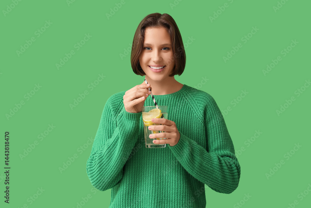 Pretty young woman with glass of infused water on green background Pretty young woman with glass of infused water on green background