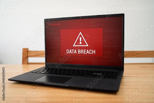 Urgent data breach notification on corporate laptop. Concept of being hacked and cyber crime.