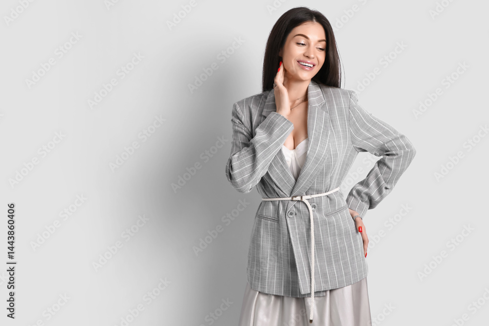 Stylish elegant young woman in grey jacket on white background Stylish elegant young woman in grey jacket on white background