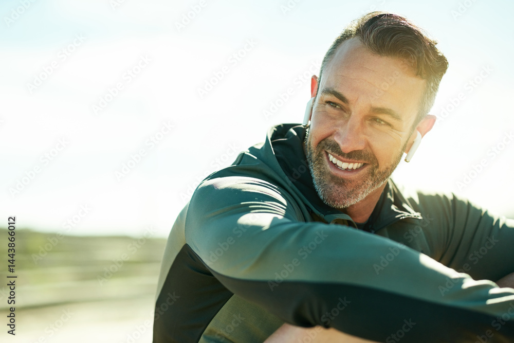 Fototapeta premium Happy man, thinking or workout break for outdoor running, fitness training or exercise space. Relax, song playlist or runner with music earphones in practice for health, resting or sports recovery