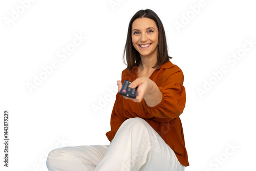 Smiling female using tv remote, lounging comfortably on transparent surface