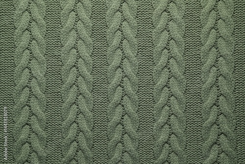 Knitted dark woolen fabric as background, top view