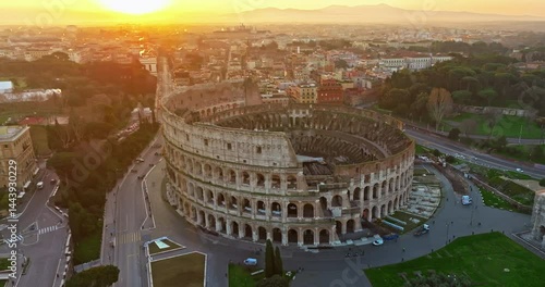 Establishing shot drone flying of the Colosseum. Famous Ancient Roman Arena. Downtown Rome, Italy. The Colosseum and the Imperial Forums in Rome. Beautiful aerial shot with drone around the Colosseum