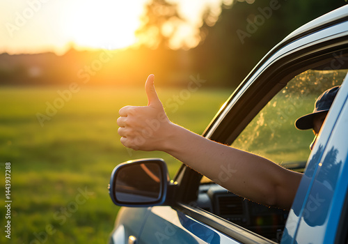 Wallpaper Mural Person giving a thumbs-up out of a car window against a stunning sunset backdrop. Torontodigital.ca