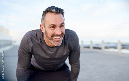 Photos Mature, man and happy for workout break with fitness fatigue, overworked and tired of running challenge