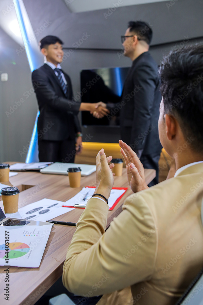 Fototapeta premium Employee get promotion, hand shaking and receive praises from boss while staff members giving applause