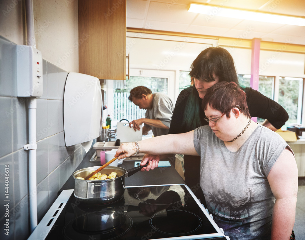 Family, down syndrome and cooking by mother and girl in a kitchen at home, bonding while learning together. Parent teaching daughter with special needs to prepare food and enjoy independence