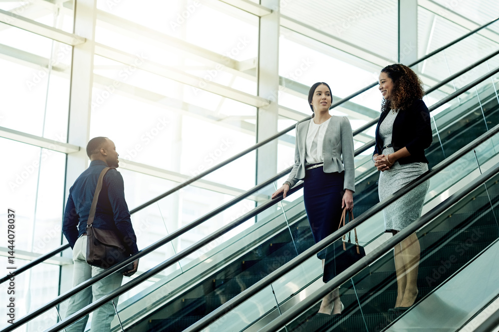Employees, escalator and morning in office building for business, new day or coworkers on lift. People, corporate team or stairs in company with meeting schedule, discussion or planning productivity Employees, escalator and morning in office building for business, new day or coworkers on lift. People, corporate team or stairs in company with meeting schedule, discussion or planning productivity