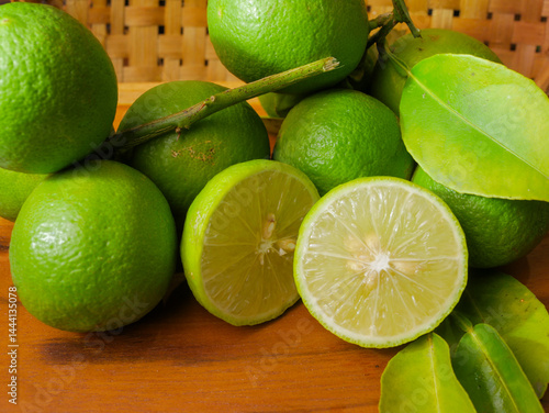 Close up of fresh lime with leaves, whole and half, green limes, natural, fruit