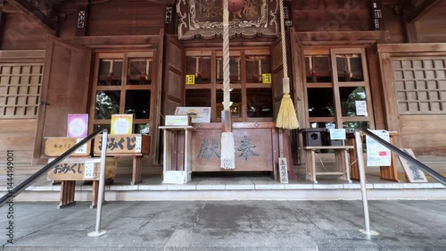 Wooden Shinto shrine front in Sakura Park Aomori, calm spiritual scene with details