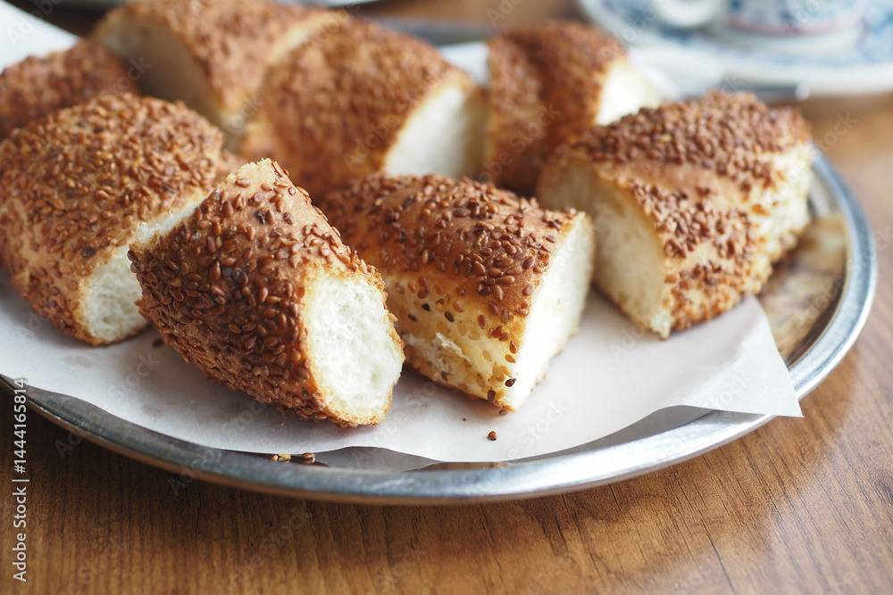 Freshly baked simit on a silver platter in a cozy setting Freshly baked simit on a silver platter in a cozy setting