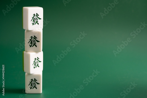 Close-up of mahjong tiles on a green surface,Mahjong (mah jongg, mah-jongg, and mahjongg) is a tile-based game that was developed in the 19th century in China