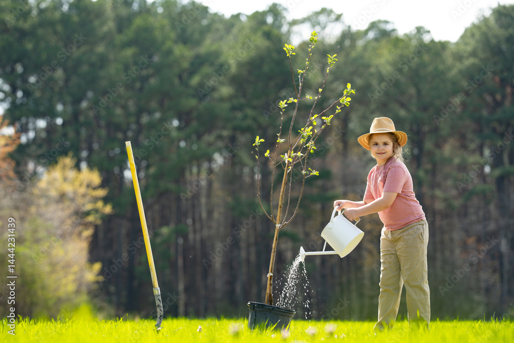Kid cultivating tree with shovel. Child planting tree on backyard. Child plant tree in spring field. Little gardener with watering can and shovel.