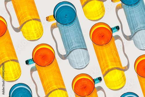 Colored shiny drink Glasses still life with shadow and sunlight reflections on white, minimal style aesthetic top view summer, refraction at glass orange blue cups, creative contemporary pattern