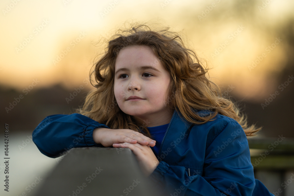 Childhood. Blonde kid dreams. Child thoughtful expression. Little thinker enjoying a carefree day. Happy kid portrait. Dreams in a child eyes. Quiet moment of childhood imagination.