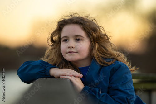 Obraz na płótnie Childhood. Blonde kid dreams. Child thoughtful expression. Little thinker enjoying a carefree day. Happy kid portrait. Dreams in a child eyes. Quiet moment of childhood imagination. w salonie