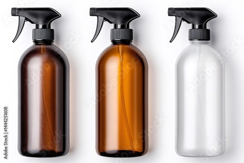Three spray bottles for cosmetic products standing on white background