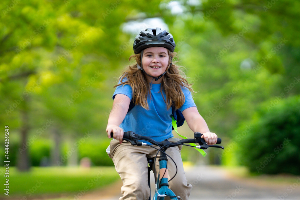Child bike ride. Child biking down summer road. Kid riding bicycle with smile. Child cycling. Kid ride on bike. Happy boy on bike. Child biking outdoors. Children biking. Little biker.