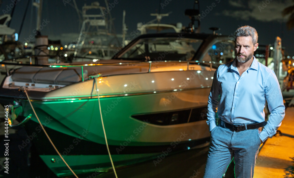 Rich businessman near yacht. Wealthy businessman enjoying luxury lifestyle. Businessman on a private yacht. Financial freedom. Expensive yacht with a rich businessman. VIP premium elite concept.