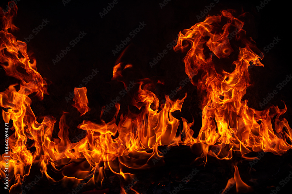 Obraz premium Fire blaze flames on black background. Fire burn flame isolated, abstract texture. Flaming explosion with burning effect. Fire wallpaper, abstract art pattern.