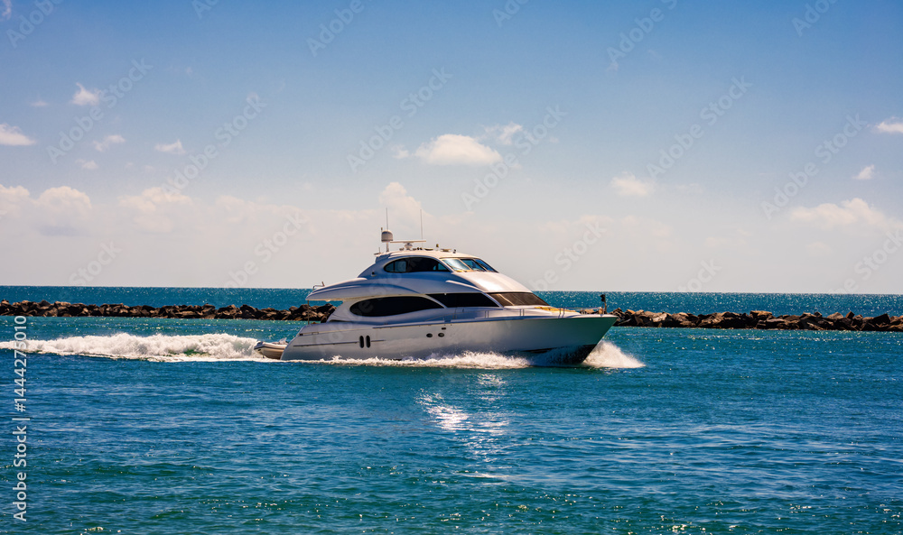 Yacht sailing on turquoise waters. Luxury superyacht at sea. Miami Beach with yachts. Tropical seascape with a sailboat. Cruise ship near the coastline. Sunset yacht voyage in Florida. Yacht in ocean.