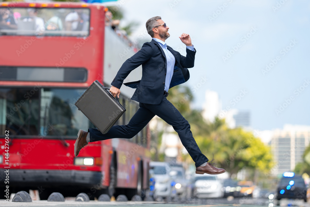Business jump. Businessman jumping in the street. Businessman in a suit running late and jump. Busy business man in jump motion. Confident businessman office worker jump up with excitement.