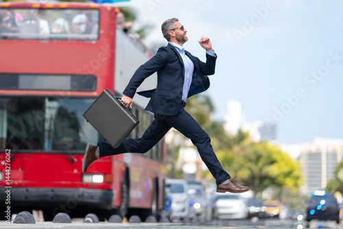 Obraz na płótnie Business jump. Businessman jumping in the street. Businessman in a suit running late and jump. Busy business man in jump motion. Confident businessman office worker jump up with excitement. w salonie