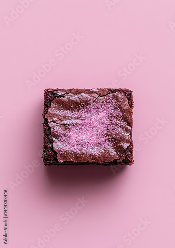 Cute brownie square dusted with pink glitter sugar presenting a sweet, playful dessert presentation  