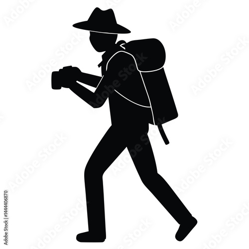 Silhouette Hiker With Backpack And Hat Holding Camera On Adventure Trip.