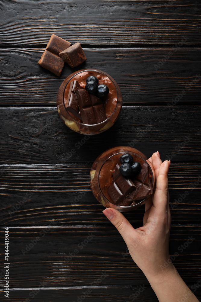 Chocolate mousse in a glass on a dark background.
