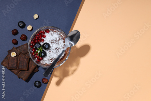 Obraz na płótnie Chocolate mousse with blueberries and pomegranate, on a peach background. w salonie
