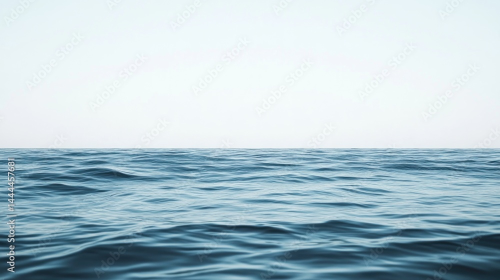 Fototapeta premium Calm ocean waves meet a pale sky