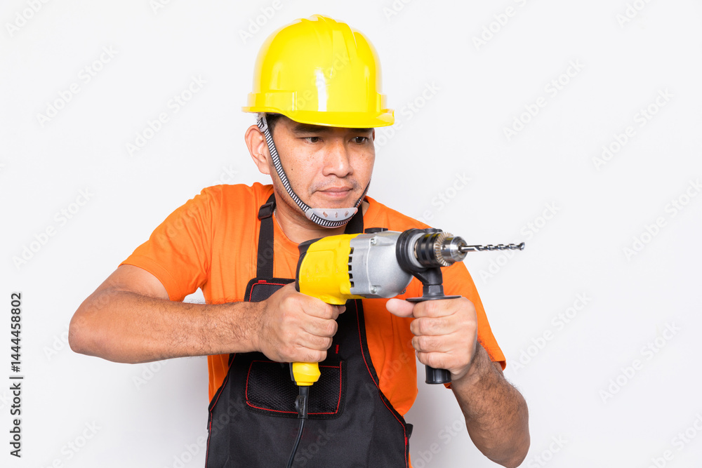 Portrait worker in black uniform with electric drill isolated on white background Portrait worker in black uniform with electric drill isolated on white background